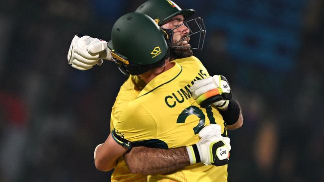 Australia's Glenn Maxwell celebrates with his team captain Pat Cummins after scoring a century. Photo by Arun SANKAR / AFP)