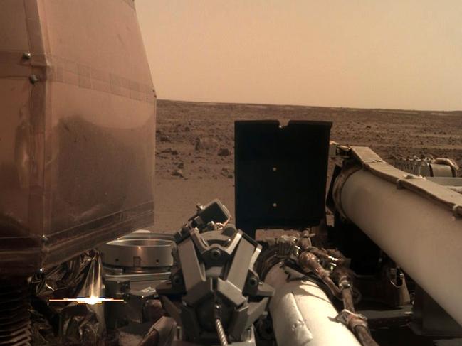 The camera’s transparent dust cover is still on in this image, to prevent particulates kicked up during landing from settling on the camera’s lens. Picture: NASA/JPL-CALTECH/AFP