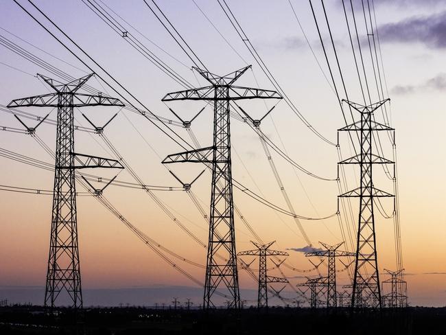 Electricity pylons during dusk evening sky sunset. Energy generic