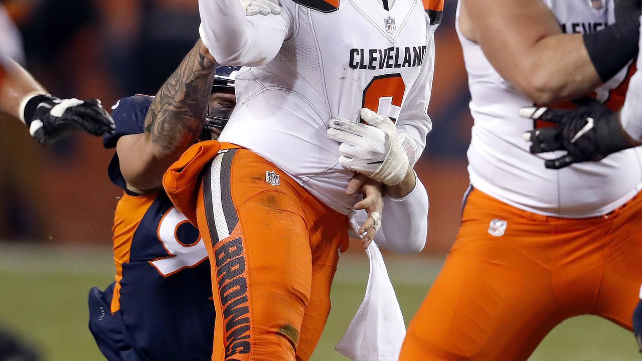 Denver Broncos defensive end Adam Gotsis, rear, forces Cleveland Browns quarterback Baker Mayfield.