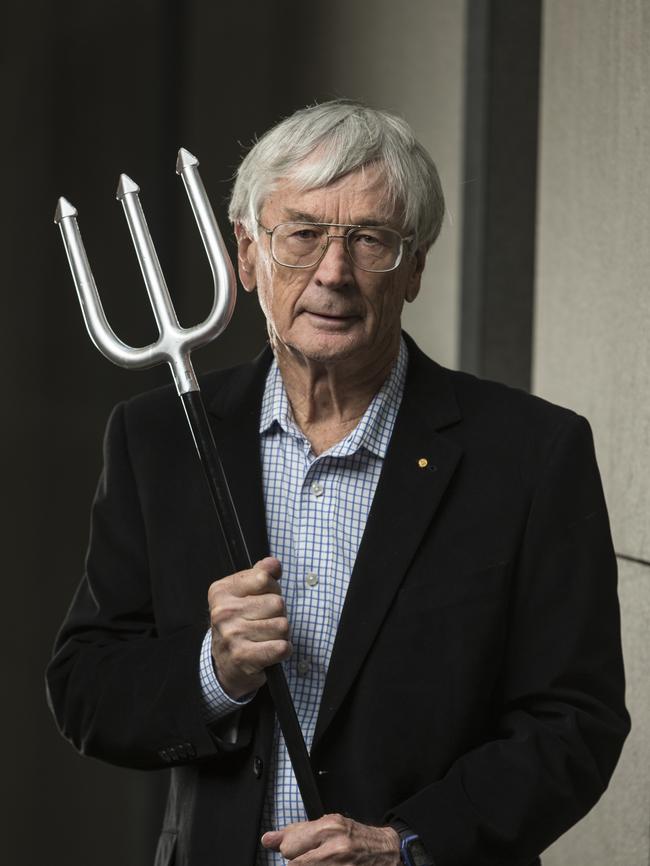 Dick Smith holding his pitchfork — a prop he intends to use to warn pollies of the “revolution” brewing. Picture: Ross Swanborough