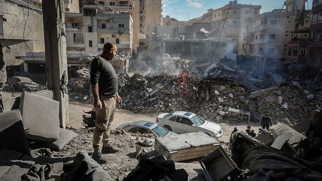 Returning residents take in the apartments destroyed by airstrikes in Tyre. Picture: Oliver Marsden/The Times