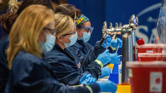 Medical staff workers prepare syringes with doses of the Pfizer-BioNTech COVID-19 Vaccine. Picture: AFP.