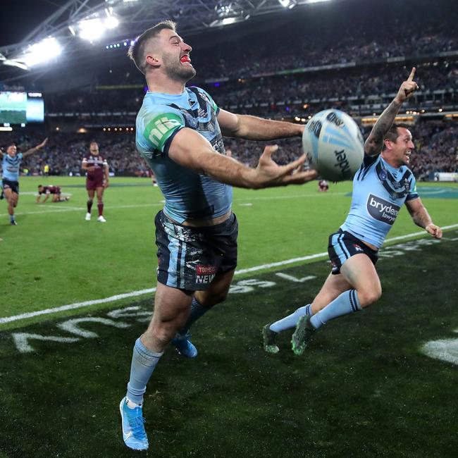 NSW’s James Tedesco (left) and Mitchell Pearce celebrate the Origin series-winning try. Picture: Phil Hillyard