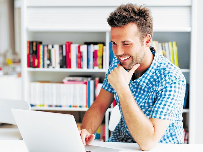 Casual man working on laptop in library