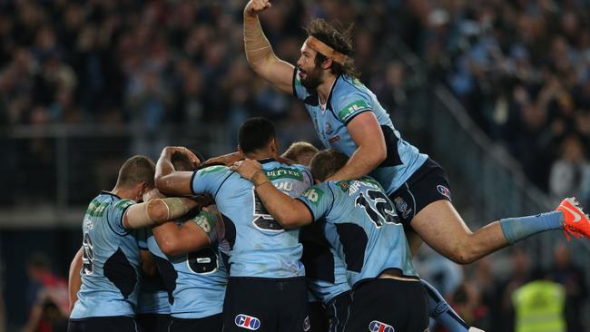 Aaron Woods jumps on Blues teammates to celebrate Trent Hodkinson’s try. Picture: Phil Hillyard