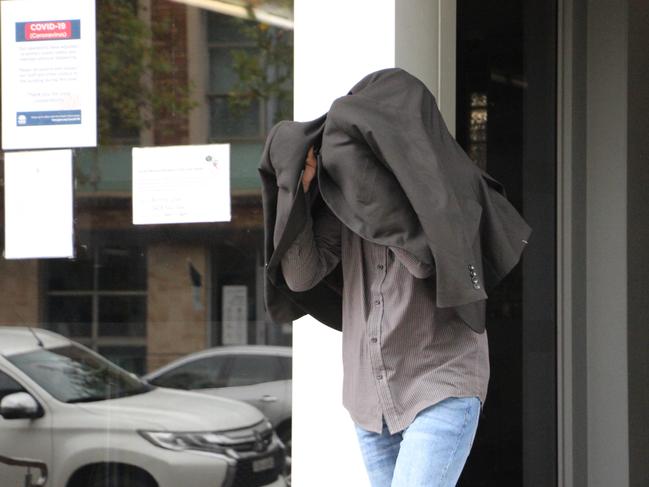 Anthony Lesley Jones covers up leaving court. Picture: Fiona Killman