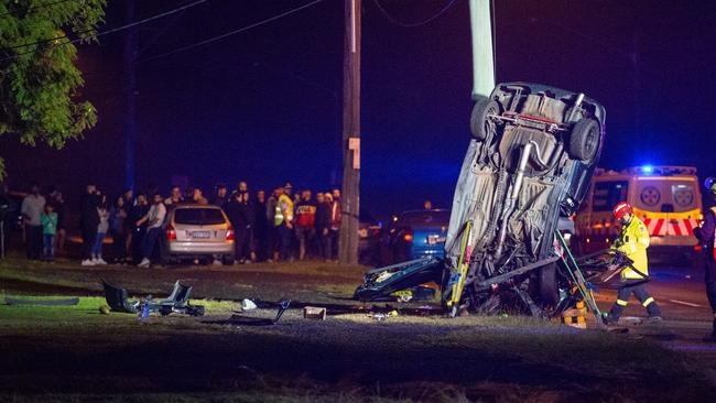 Bystanders watch on as emergency crews helped four people who were seriously injured after this horror crash. Picture: Steve Tyson