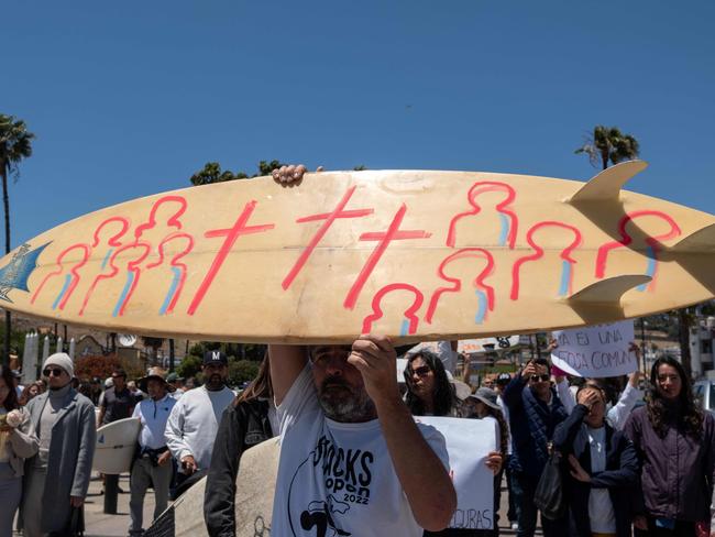 Members of the surfing community protest against insecurity after two Australians and an American surfers went missing last week during a surfing trip, in Ensenada, Baja California state, Mexico, on May 5, 2024. Three bodies believed to be those of two Australian brothers and an American who disappeared on a surfing trip in Mexico have bullet wounds to the head, authorities said Sunday. (Photo by Guillermo Arias / AFP)