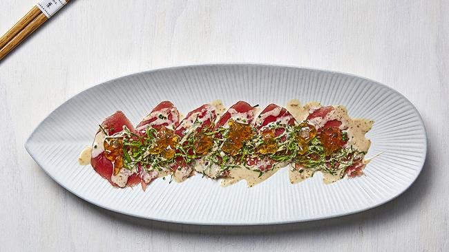 Yuzu carpaccio with chilli sesame dressing.