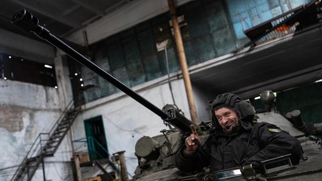 A Ukrainian soldier in the driver’s hatch of a BMP-2 tank. Picture: Getty Images