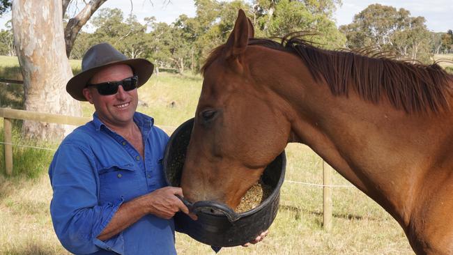 Simon Tolley feeds Gytrash at his Woodside winery. Picture: Supplied