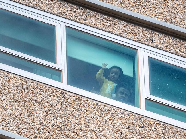 Public Housing towers in Flemington - Lockdown. A resident in lockdown looks out the window. Picture: Jake Nowakowski