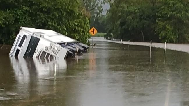 Bruce Highway is closed between Ingham and Cardwell due to flooding of the Seymour River. A truck tipped over after veering off the roadway on Tuesday morning. Picture: Jeff Lion