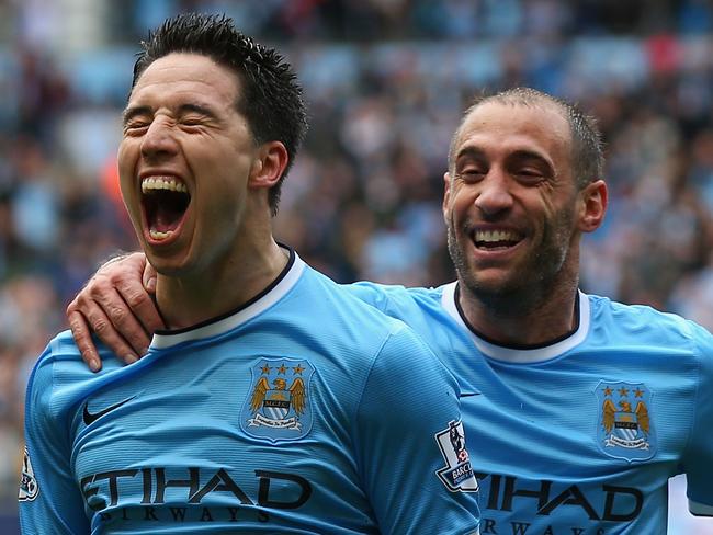 MANCHESTER, ENGLAND - MAY 11: Samir Nasri of Manchester City celebrates scoring the first goal with team-mate Pablo Zabaleta (R) during the Barclays Premier League match between Manchester City and West Ham United at the Etihad Stadium on May 11, 2014 in Manchester, England. (Photo by Alex Livesey/Getty Images)