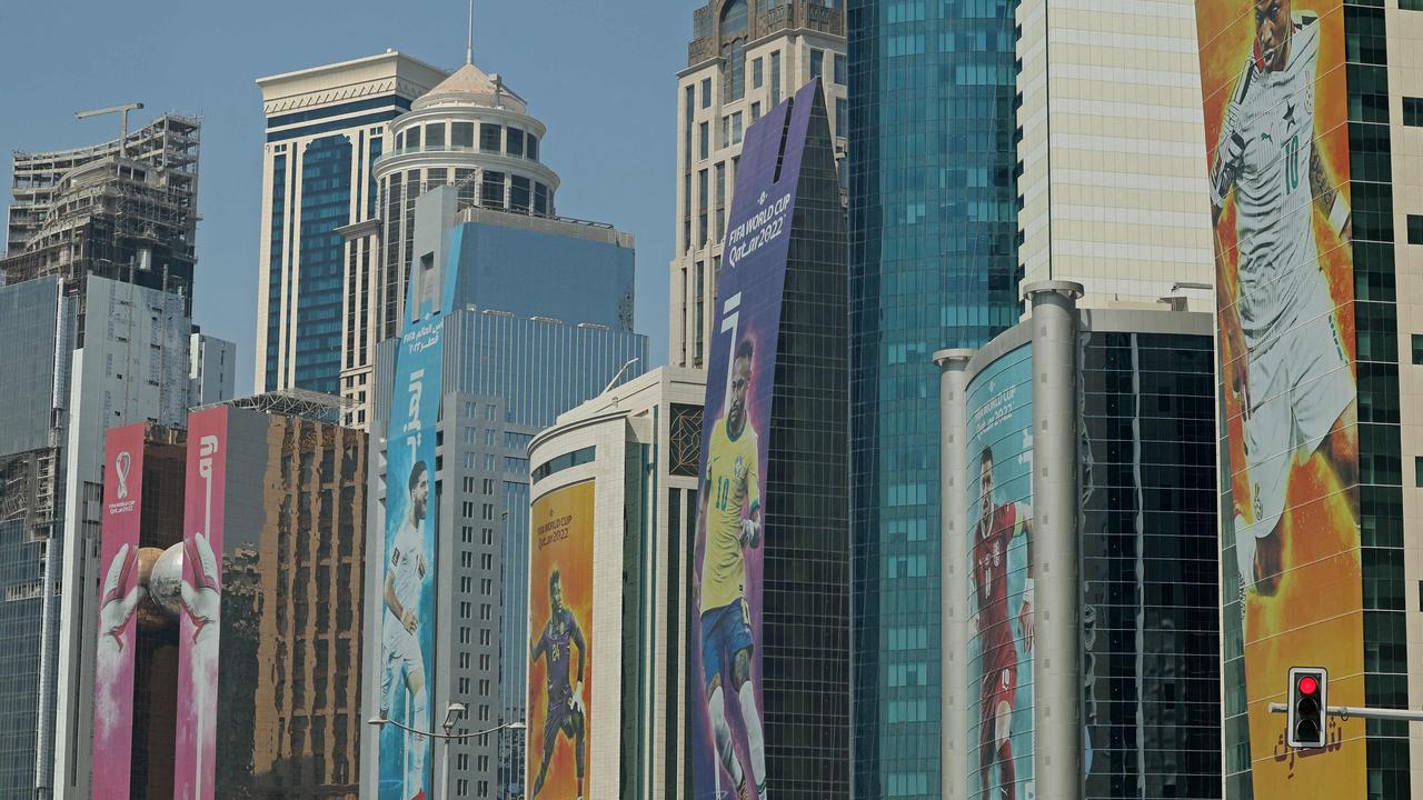 TOPSHOT - Banners depicting footballers hang on buildings in the Qatari capital Doha ahead of this year's FIFA football World Cup, on October 16, 2022. (Photo by Giuseppe CACACE / AFP)