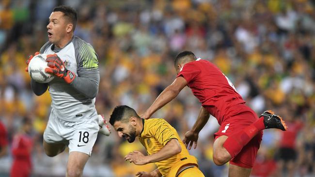 Vukovic (left) competes for possession while playing for Australia against Lebanon. Picture: AAP