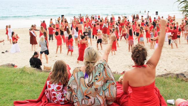 V DAY: In the early morning light on Main Beach on Friday around 350 women men and children gathered and danced in support of the global One Billion Rising movement to stop violence against women.  Photo Veda Dante / Byron Shire News