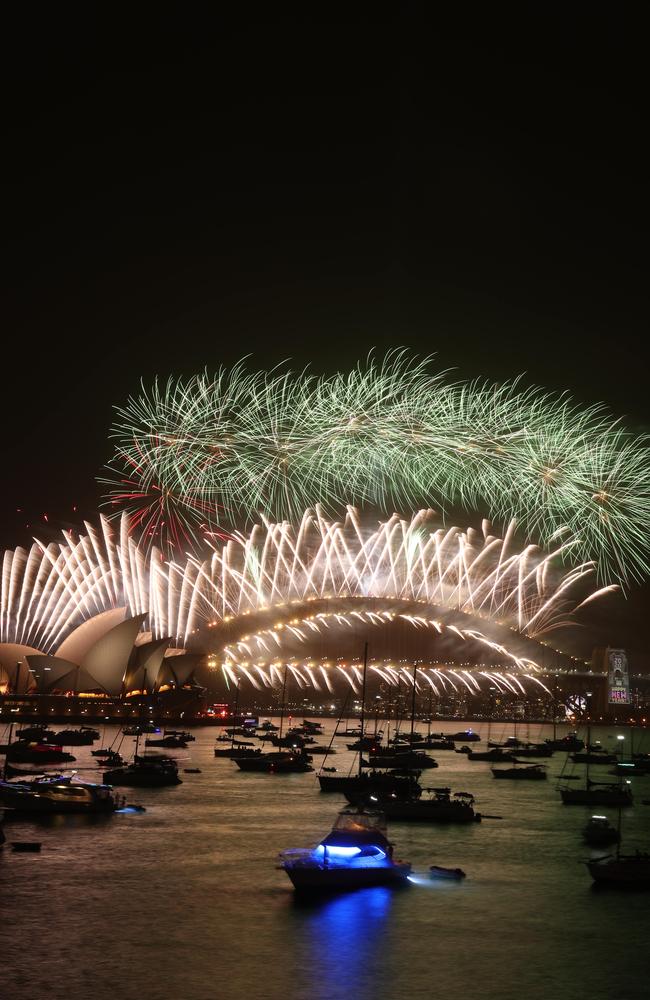 The harbour bridge lights up for the Midnight fireworks display, New Years Eve Fireworks on the Sydney Harbour Bridge as seen from Mrs Macquarie's Point. Picture Rohan Kelly