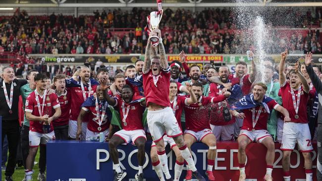 Wrexham's James McClean raises the trophy as they win. AP Photo/Jon Super.
