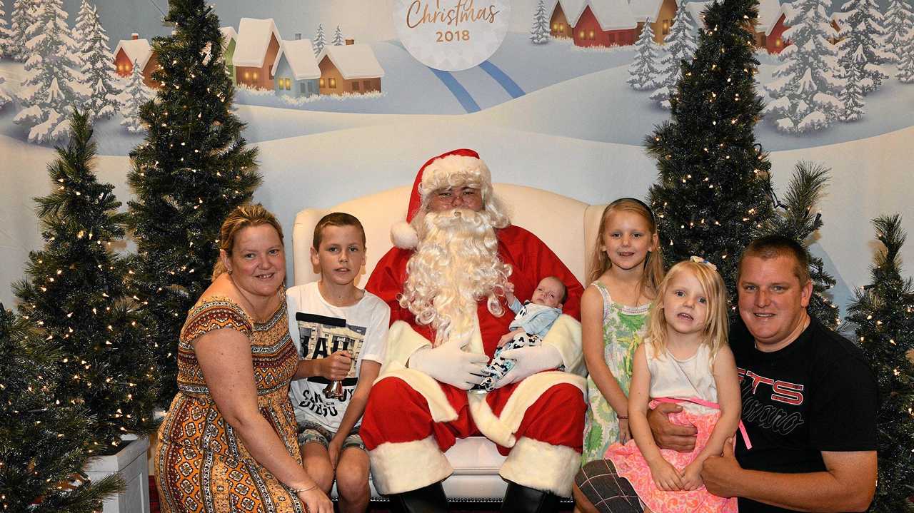 MIRACLE BABY: Harry meets Santa Claus with mum, dad, brother and two sisters. Picture: Denise Keelan