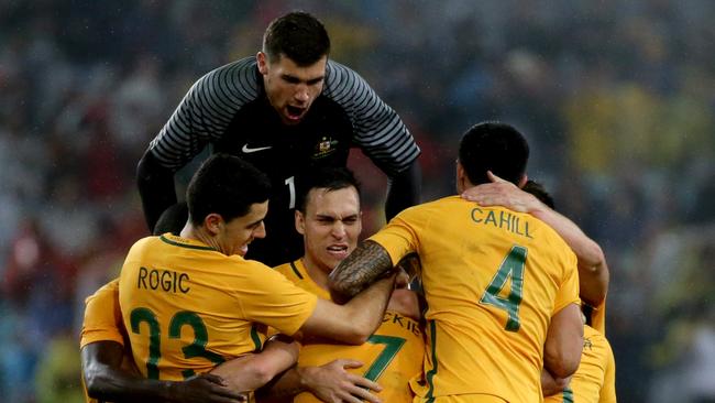 Socceroos celebrate a goal.