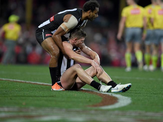 Travis Varcoe picks up Taylor Adams after the tough loss. Pic: AAP