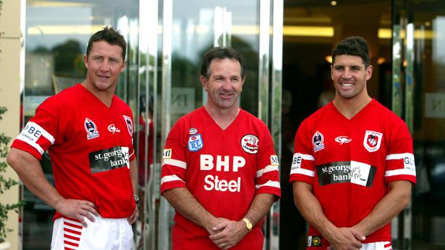 St George Illawarra players Shaun Timmins (L) and Trent Barrett (R) with John Dorahy at the unveiling of the Dragons’ 2004 heritage jersey. The photo was ironically taken at the St George Leagues Club in Kogarah.