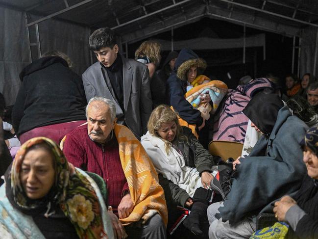 Earthquake survivors sit sheltering in a tent in Hatay. Picture: AFP