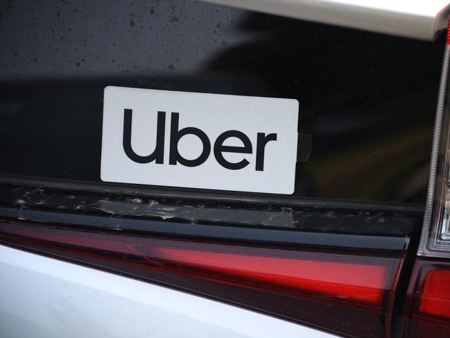 An Uber sticker is seen on a car at the start of a protest by ride share drivers on August 20, 2020 in Los Angeles, California. - Rideshare service rivals Uber and Lyft were given a temporary reprieve on August 20 from having to reclassify drivers as employees in their home state of California by August 21. (Photo by Robyn Beck / AFP)