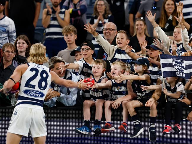 GEELONG, AUSTRALIA - MARCH 16: Oliver Dempsey of the Cats greets Cats fans during the 2024 AFL Round 01 match between the Geelong Cats and the St Kilda Saints at GMHBA Stadium on March 16, 2024 in Geelong, Australia. (Photo by Michael Willson/AFL Photos via Getty Images)