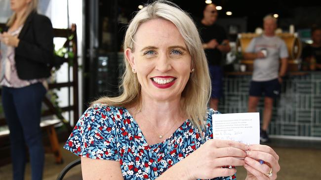 Tourism Minister Kate Jones fills out the new government required form for diners at the Hot Shott cafe. Picture: Tertius Pickard