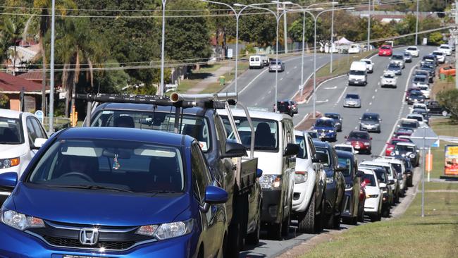 Long queues of cars snake along the road at the mobile Covid testing centre at 146 Olsen Ave at Arundel on Monday. Picture: Glenn Hampson