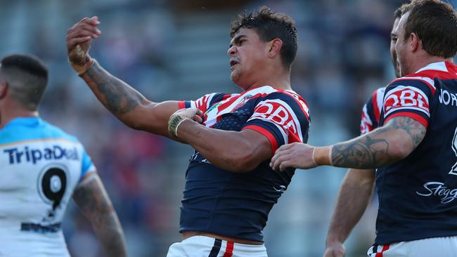 Latrell Mitchell celebrates a try against the Titans.