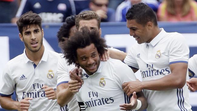 Marcelo is surrounded by teammates after scoring against Chelsea.