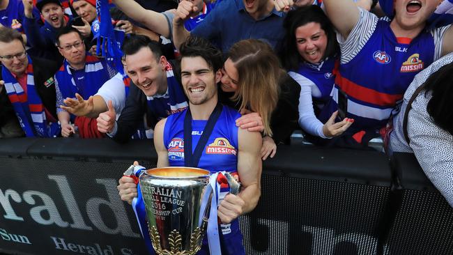 Western Bulldogs skipper Easton Wood carries the treasured silverware around the MCG after his side’s famous win. Picture: Alex Coppel