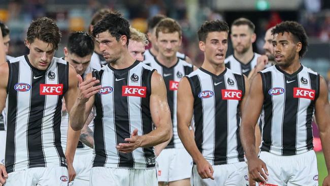 A dejected Collingwood outfit makes it way off the field after notching up a third consecutive defeat this season. Picture: AFL Photos via Getty Images