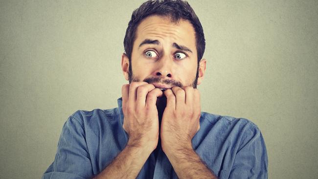 Portrait anxious young man biting his nails fingers freaking out, frightened, generic, scared