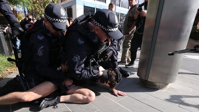 Police arrest a protester. Picture: Jake Nowakowski