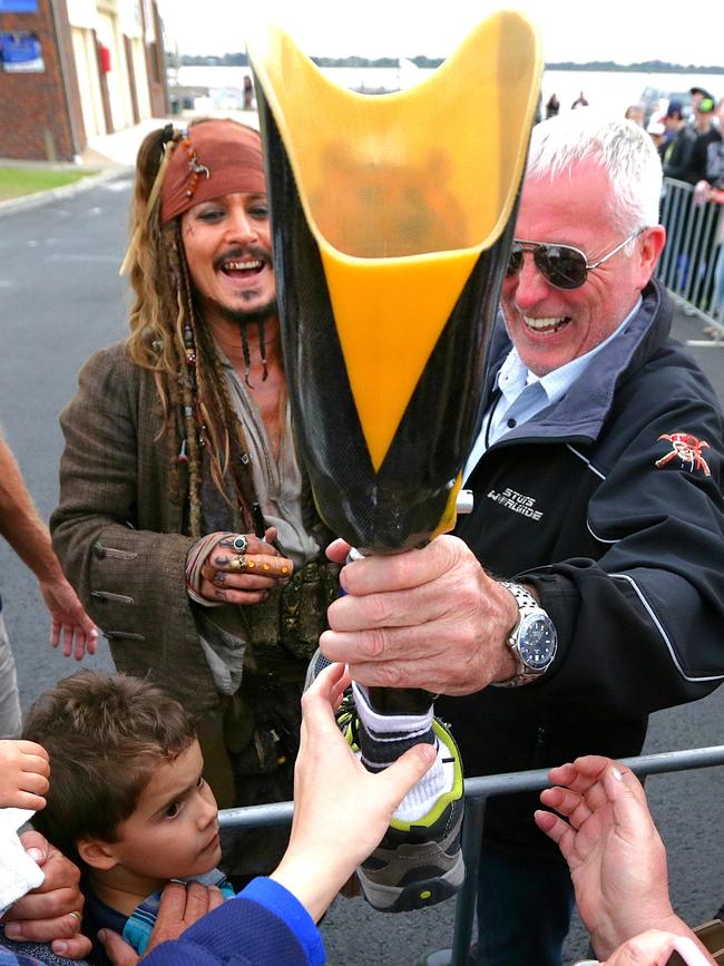 Johnny Depp signs a fans prosthetic leg at Cleveland. Picture: Peter Wallis