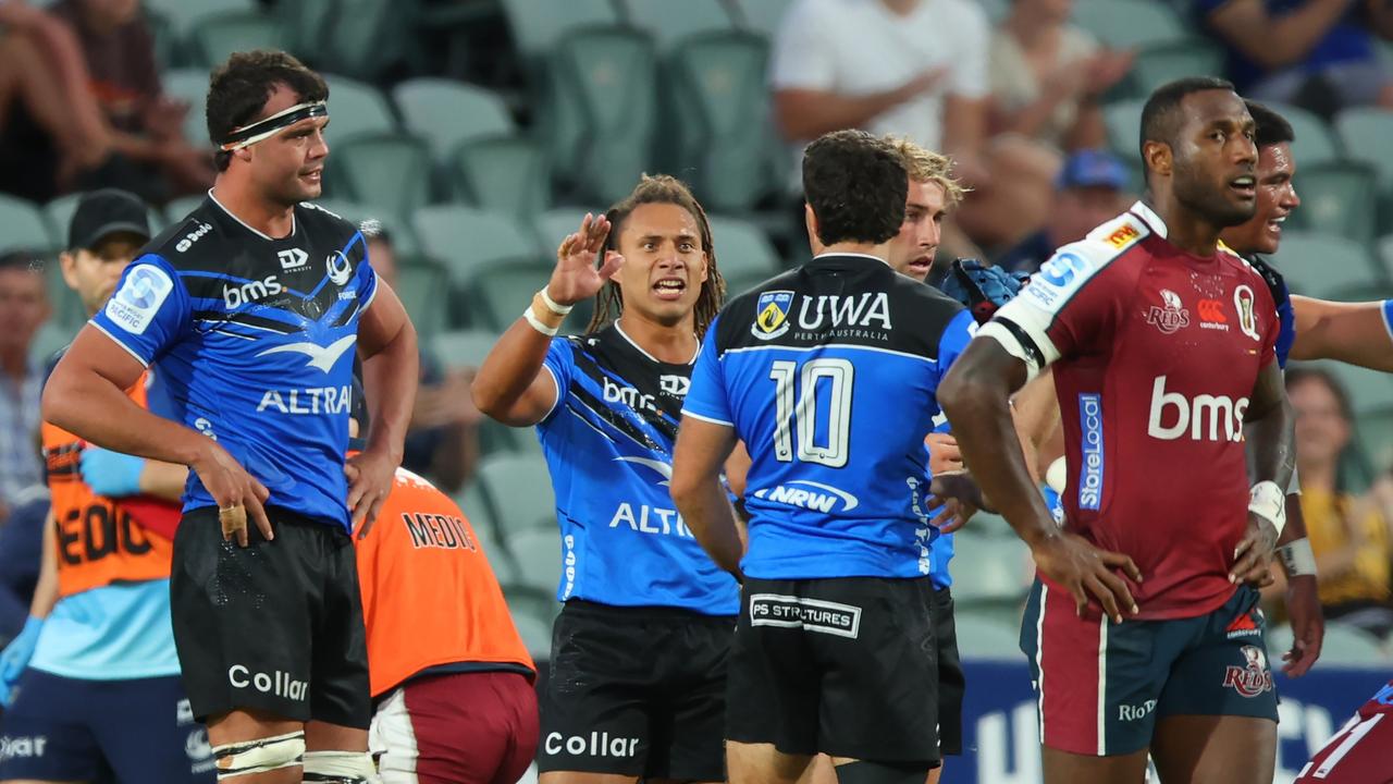 Force players celebrate as Reds winger Suliasi Vunivalu reflects on his side’s loss. Picture: James Worsfold/Getty Images