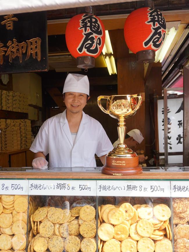 The Melbourne Cup visits a Senbei stall in Tokyo. Picture: Nicolas Datiche