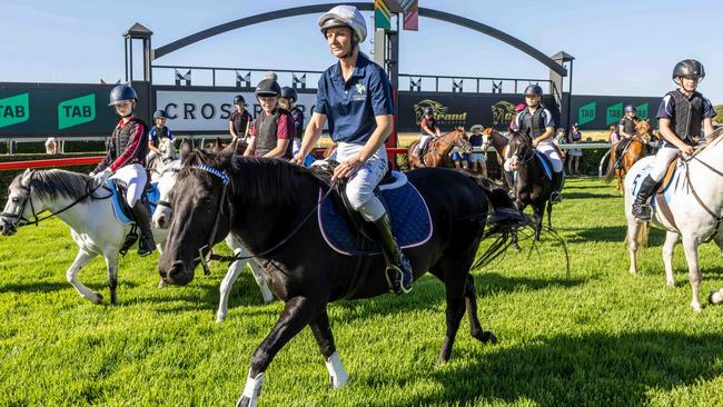 Jamie Kah joins in with the Pony Racing Kids at Morphettville Racecourse. Image/Russell Millard Photography