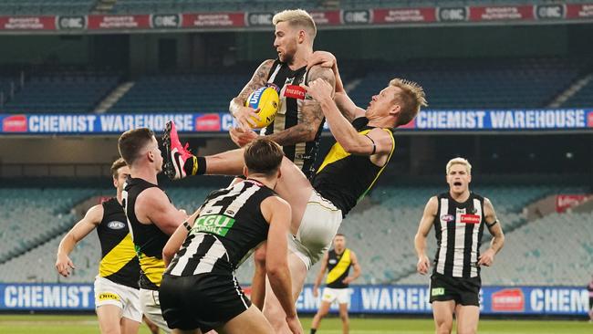 Jeremy Howe flies for a mark in front of Jack Riewoldt. Picture: AAP