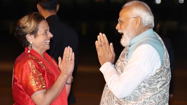 India's Prime Minister Narendra Modi (R) is greeted as he arrives at the Sydney international airport on Monday night. Picture: David Gray / POOL / AFP