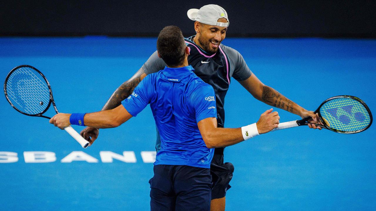 Nick Kyrgios and Novak Djokovic chest-bump after their victory.