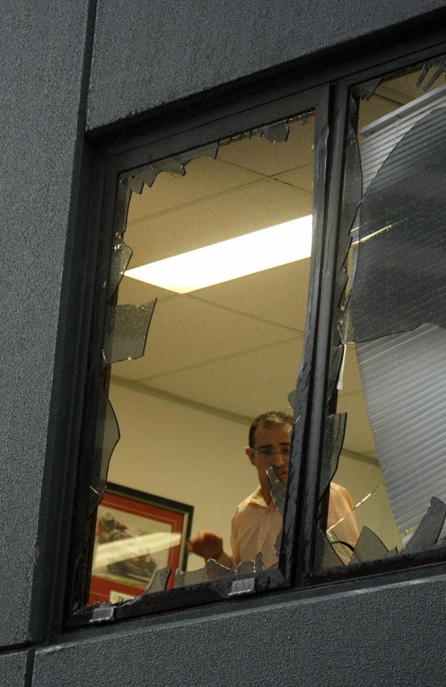 Ron Bakir pictured covering the broken window.