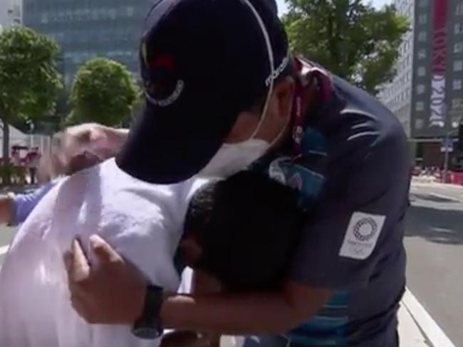 Flores hugs his coach in emotional scenes after the race.