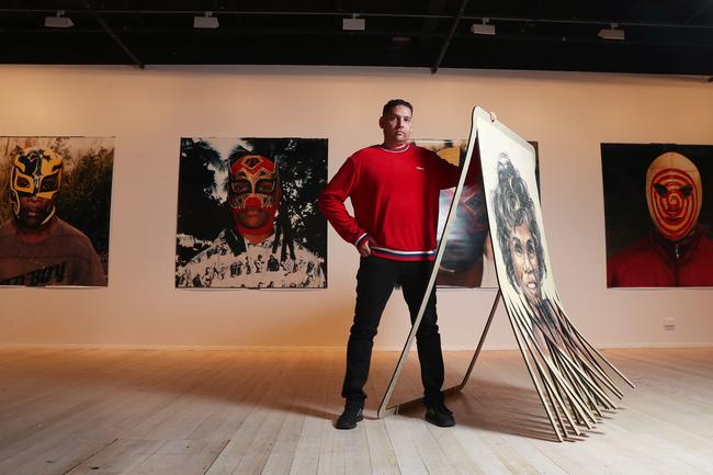 Australian contemporary artist Tony Albert with works from his exhibition Confessions. Picture: NIKKI DAVIS-JONES
