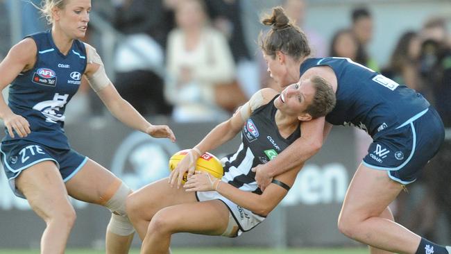 Emma Grant of Collingwood is collared by Brianna Davey.